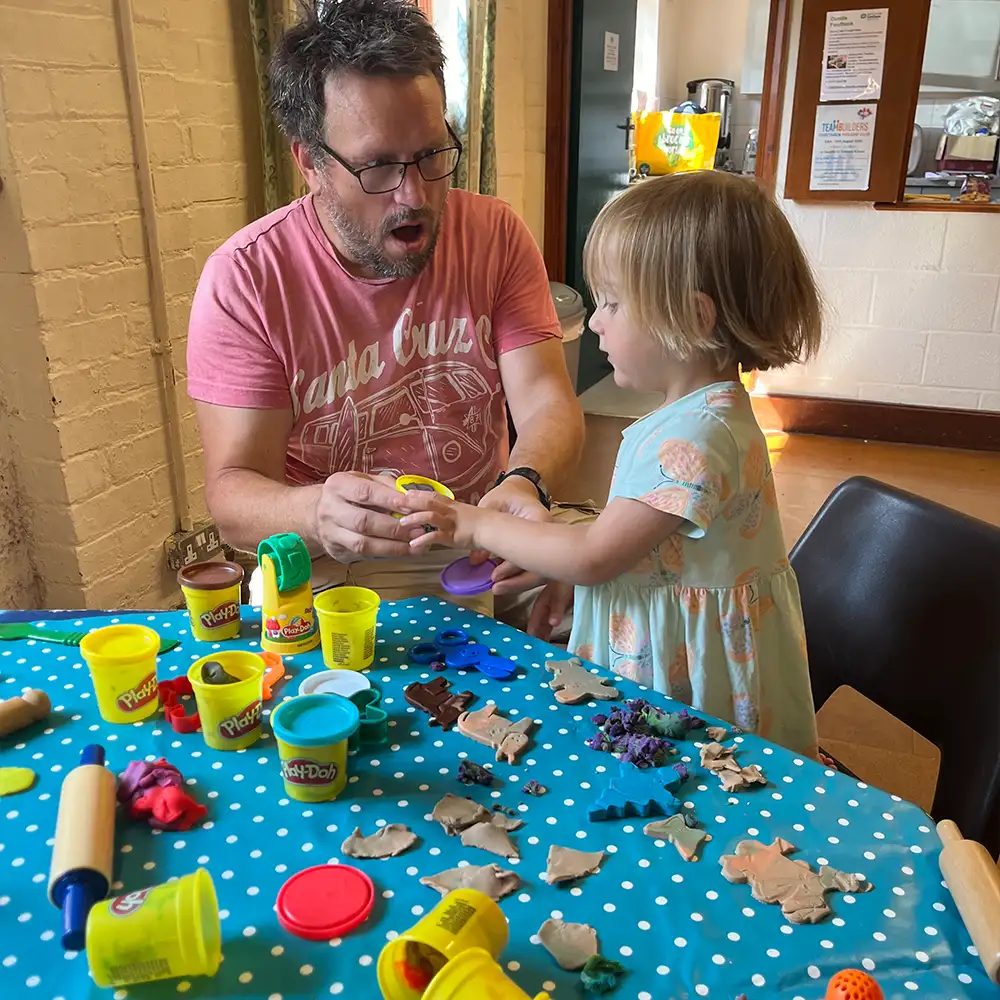 Adult and child taking part in a colourful craft activity