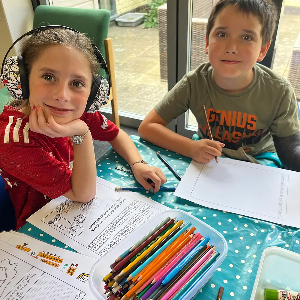 Children colouring and drawing together