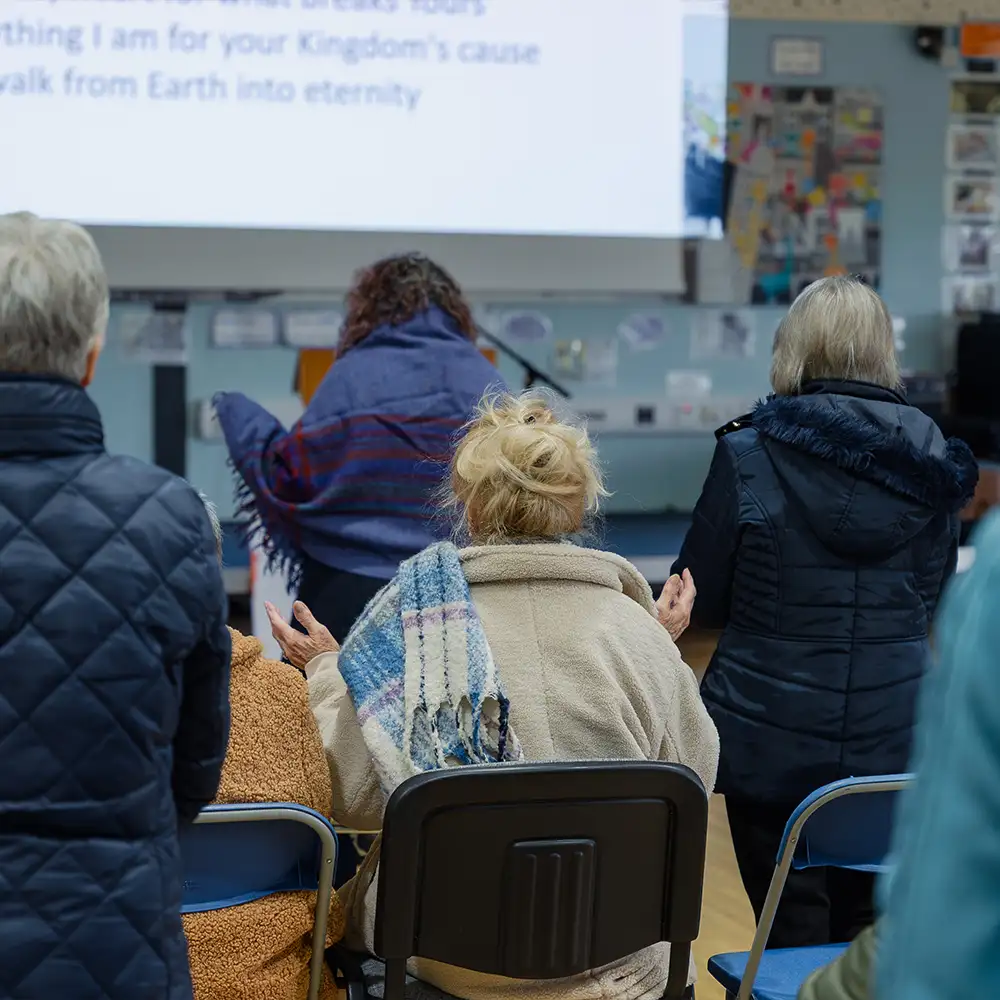 People worshipping in the the church hall
