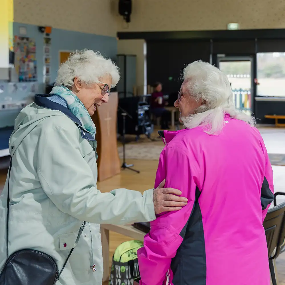 Two women chatting before the church service