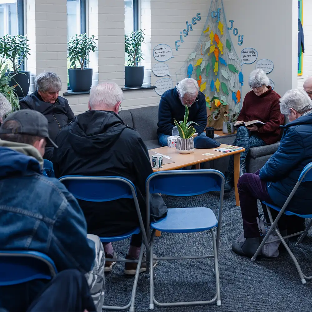 People praying together at a church community gathering